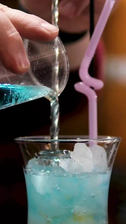 The bartender makes a shot at the bar. Making a Hiroshima cocktail in a Stock Footage 323532207