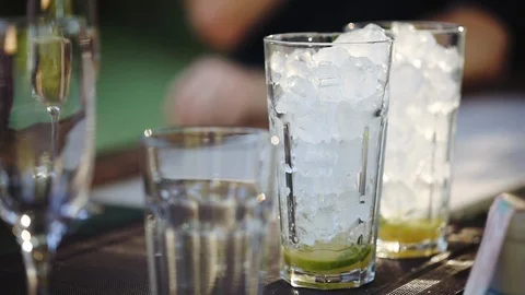 Bartender makes summer cool refreshing alcoholic drink with ice Stock Footage 120579057