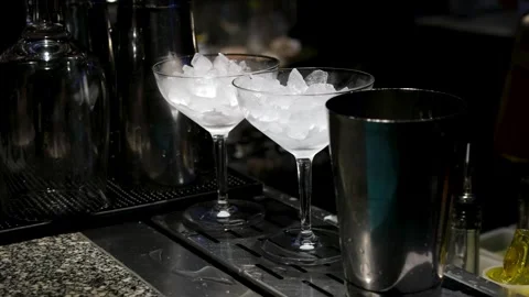 Bartender makes two glasses of cocktail Aperol spritz on bar counter, adds fresh Stock Footage 326627095