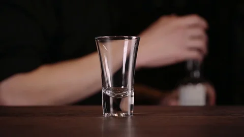 Bartender making alcohol coctail in restaurant. Expert barman is adding Stock Footage 97825657