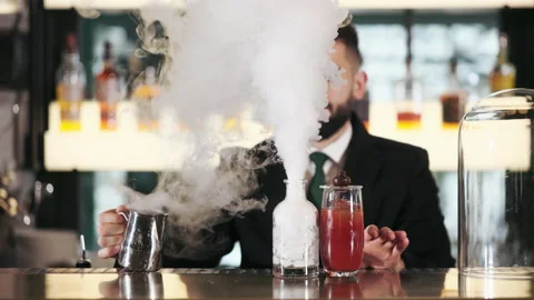 Bartender making alcoholic cocktail with steam from dry ice Stock Footage 196224995