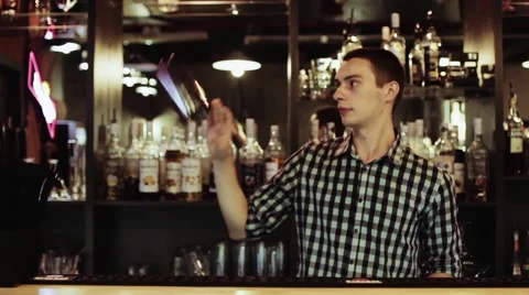 Bartender making amazing tricks with two glasses, standing behind the bar Stock Footage 65217705