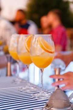 Bartender making and decorating orange cocktail close-up Stock Photos