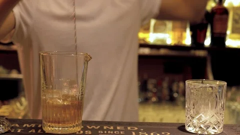 Bartender making cocktail and mixing another in glass, mition blur Stock-Footage 118534798