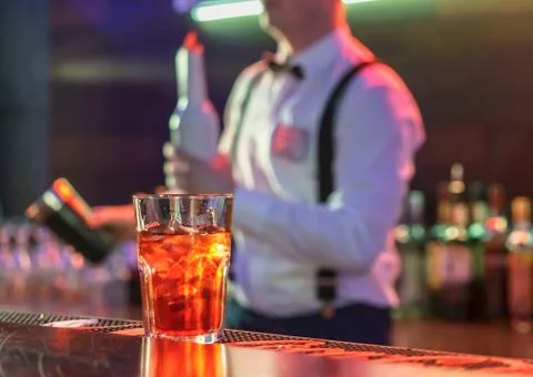 Bartender is making cocktail at bar counter Stock Photos