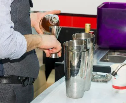 Bartender is making drinks behind the bar Stock Photos