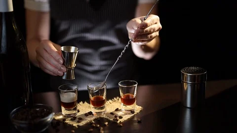 Bartender making a layered cocktail shot Stock Footage 125212523