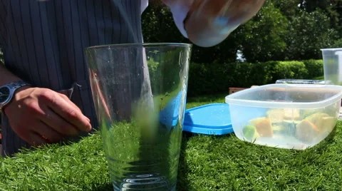 Bartender Making Mojito Cocktail. The bartender mixes the ingredients in a glass Stock Footage 64978964