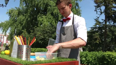 Bartender Making Mojito Cocktail. The bartender mixes the ingredients in a glass Stock Footage 64983179