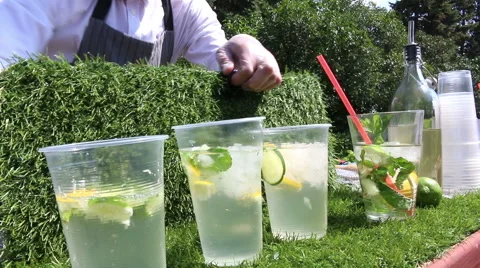 Bartender Making Mojito Cocktail, The bartender pulls out and adds the ice in Stock Footage 64983368