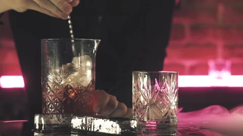 Bartender making Negroni cocktail at the bar Stock Footage 125280324