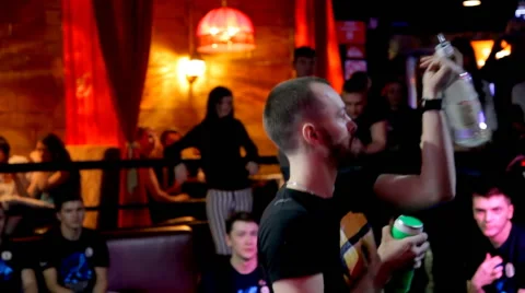Bartender  masterfully juggles bottles in the night club. Stock Footage 49366256