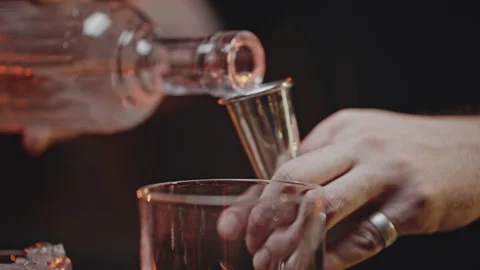 Bartender Pours Red Liquid From Jigger Into Mixing Cup Stock Photo