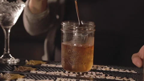 A bartender mixes a cocktail in slowmotion. Stock Footage 148103539
