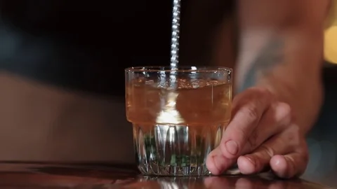 The bartender mixes a cocktail with a spoon Stock Footage 128070160