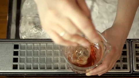 Bartender mixes a cocktail with a spoon, slow motion, top view Stock Footage 75707832