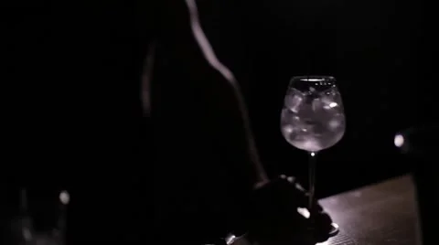 Bartender mixes the ice in the glass in the dark Stock Footage 61786240
