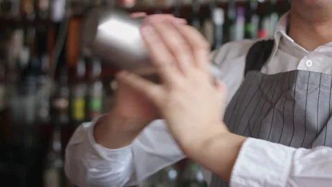 Bartender mixing coctail in shaker Stock Footage 74219324