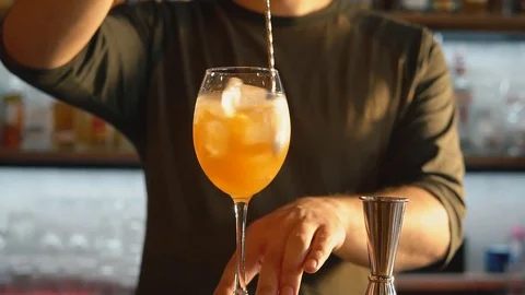 Bartender mixing exotic drink, slowmotion footage Stock Footage 76680600