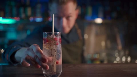 Bartender mixing modern gin tonic cocktail with ice Video stock 145804347
