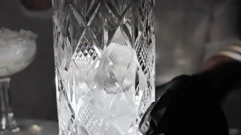 Bartender mixologist combining ingredients, stirring and making a Martini Stock Footage 132383039