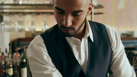 Bartender mixologist combining ingredients, stirring and making a Martini cockta Stock Footage 199461611