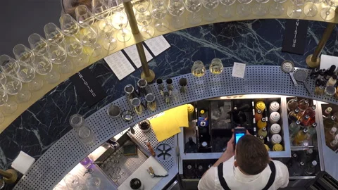 Bartender with a mobile phone in 4K. Stock Footage 123915231