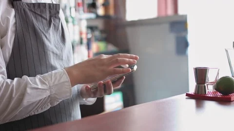 Bartender with mobile phone Stock Footage 74214607