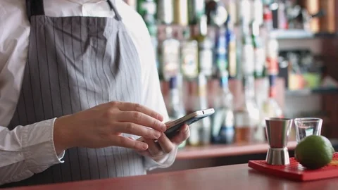 Bartender with mobile phone Stock Footage 74214692