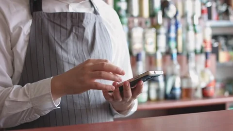 Bartender with mobile phone 動画素材 74214774
