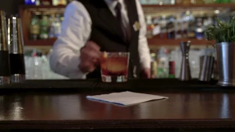 The bartender offers the cocktail he has prepared. Stock Footage 244941396