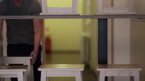 Bartender Opens Bar, Removing Barstools From Table Stock Footage 65997490