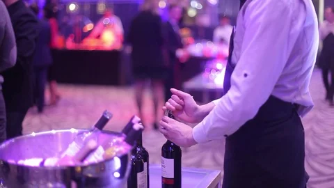 The bartender opens wine corkscrew Stock Footage 82894309