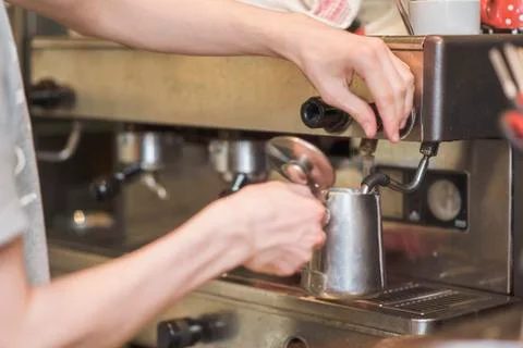Bartender or a waiter making frothy milk Stock Photos