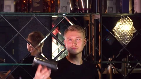 The bartender performs tricks with bottles and glasses Slow-mo Stock Footage 85125025