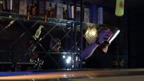 The bartender performs tricks with bottles and glasses Slow-mo Stock Footage 85128808