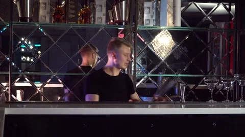 The bartender performs tricks with bottles and glasses Stock Footage 85130446
