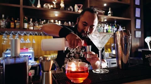 Bartender with piercings and dreadlocks making cocktail Stock Footage 65397598