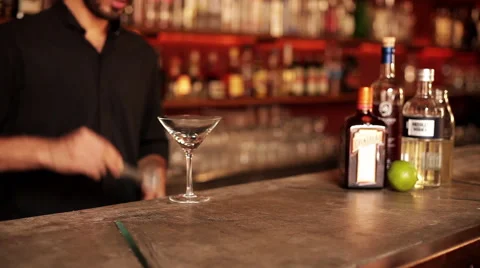 Bartender placing ice cubes in martini glass Stock Footage 63306008