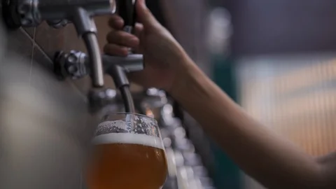 Bartender poured cold draft beer from tab into glass, selective focus Stock Footage 121617803