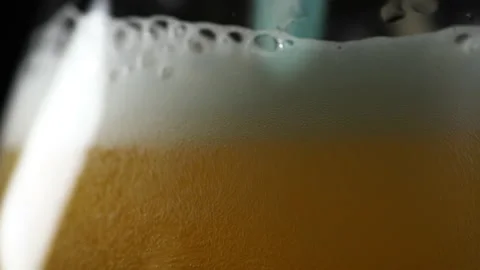 Bartender pouring beer, Carbonation bubbles, Dolly around glass, Macro Stock Footage 140271076