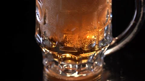 Bartender pouring beer into glass with bubbles close up Stock Footage 154450048