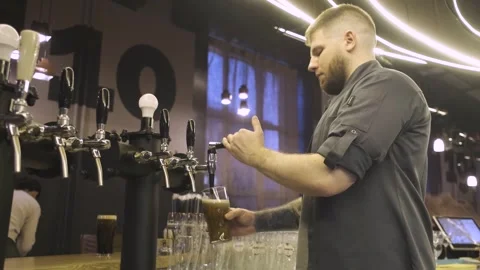 Bartender pouring beer into a glass Stock Footage 247030180