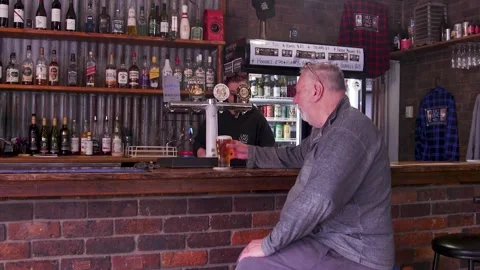 Bartender Pouring Beer For Older Man At Rustic Pub Bar Counter Stock Footage 340548189
