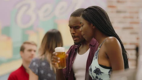 Bartender pouring beer from tap in warm sunny bar. Close up on 4k RED camera. Stock Footage 199462927