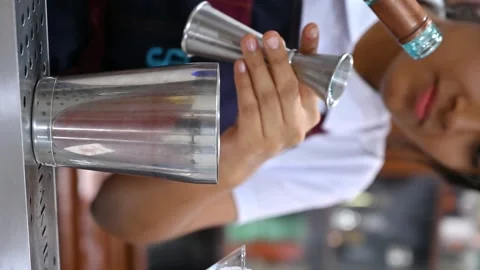Bartender pouring blue curacao into cocktail shaker Stock Footage 314337692