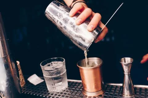 Bartender pouring Cocktail on a bar counter alcoholic drink in nightclub Stock Photos