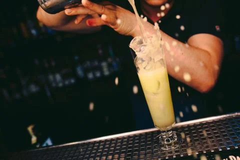 Bartender pouring Cocktail on a bar counter alcoholic drink in nightclub Stock Photos