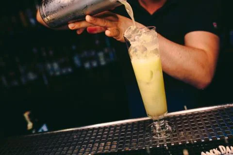 Bartender pouring Cocktail on a bar counter alcoholic drink in nightclub Stock Photos