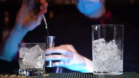 Bartender pouring cocktail Into bartending tumble with cocktail shaker Stock Footage 149125680